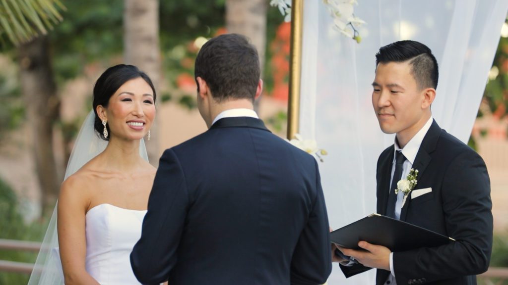 Wedding Live Stream. Close up shot of Bride smiling at Ceremony as groom gives his vows