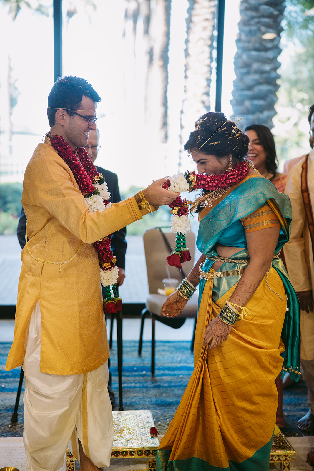 Bride and Groom exchanging flower garlands during Live Stream Indian Ceremony